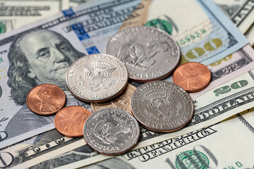 Half Dollar and one dollar coins on top of USD banknotes. Coins and paper money. US Dollar cash, finance and economy in the United States of America