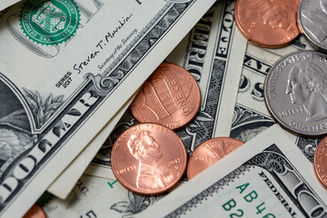 Pennies between dollar bills. US dollar paper money and coins.