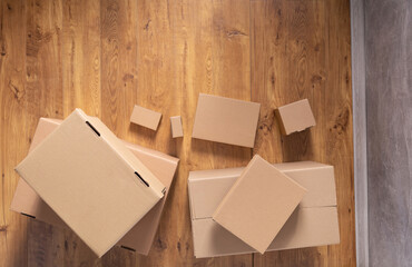 Stack of cardboard box on floor laminate background. Empty box case top view