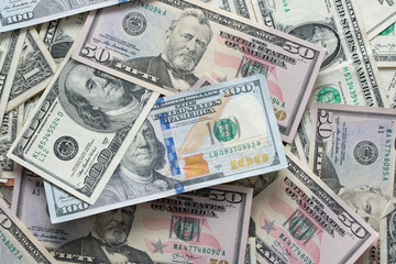 Dollar banknotes spread out. One dollar to one hundred dollar banknotes. Background with US dollar banknotes. Cash 100 and fifty dollar bills