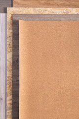 Cork roll and laminate floor on wood osb background texture. Cork background at wooden laminate floor