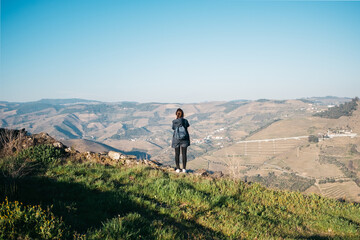 Woman taking a photo of scenic landscape in Portugal