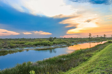 sunset in the swamp refecting in the river