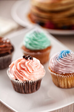 Selection of Colored Cupcakes on a Plate. High quality photo.