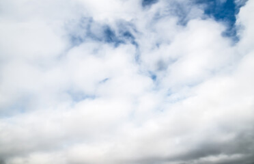 Sky with clouds in spring. White cloud formations in blue sky.