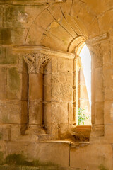 Key-shaped stonework symbol illuminated by light from a window in the 12th-century Cistercian monastery of Santa María de Moreruela. Zamora. Spain. © NATI