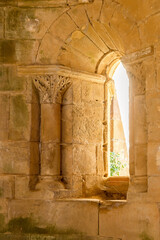 Key-shaped stonework symbol illuminated by light from a window in the 12th-century Cistercian monastery of Santa María de Moreruela. Zamora. Spain.