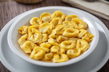Italian Tortellini In broth on a plate.