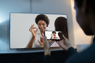 Woman Watching TV Through Smartphone