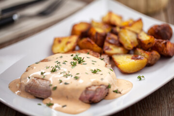 Fillet of beef with potatoes and asparagus on a plate.