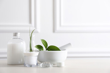 Natural ingredients for cosmetic products and laboratory glassware on white table