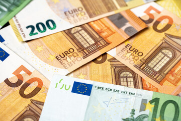 Euro banknotes as background, fifty, one hundred and two hundred euro bills, paper money. European monetary union currency