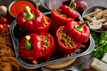 Sweet red peppers stuffed with meat and tomato in a vintage frying tray. Top view
