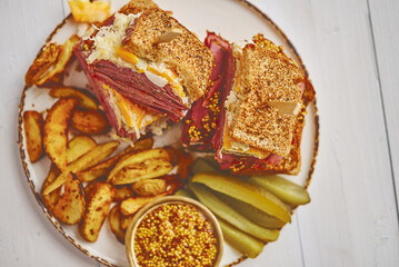 Reuben sandwich. Classic traditional American sandwich. Pastrami and corned beef on grilled bread