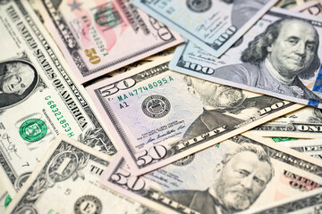 US Dollar banknotes spread out. Pattern of Dollar cash and bills. Paper money from USA. 100 One hundred Dollar bills with 50, fifty USD paper money