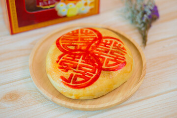 Delicious Chinese traditional cake, cake Chinese Characters on Dim Sum . Chinese Cake. traditional pastry Moon cake tray on wooden background.