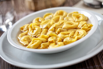 Italian Tortellini In broth on a plate.