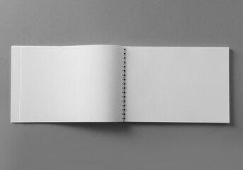 Blank notebook on light grey background, top view. Mockup for design