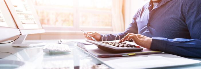 Financial Accounting. Man Using Calculator