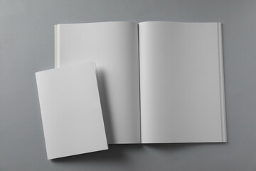 Blank brochures on light grey background, flat lay