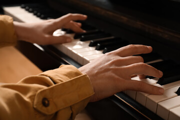 Obraz premium Young woman playing piano, closeup. Music lesson