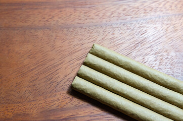 Cigar on a wooden table and whiskey  Soft focus image.