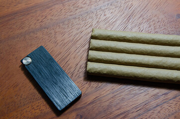 Cigar on a wooden table and whiskey  Soft focus image.