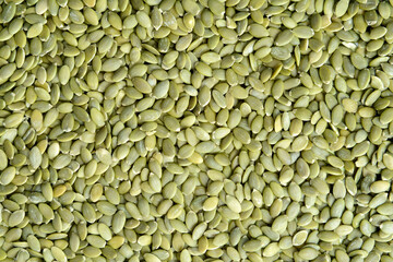 Green color raw whole hulled pumpkin seeds.