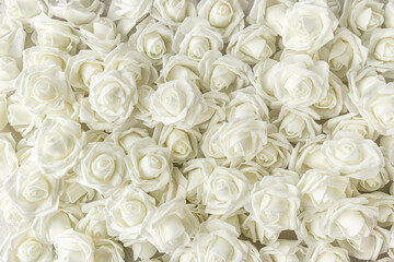background of many fake white roses. Top view.