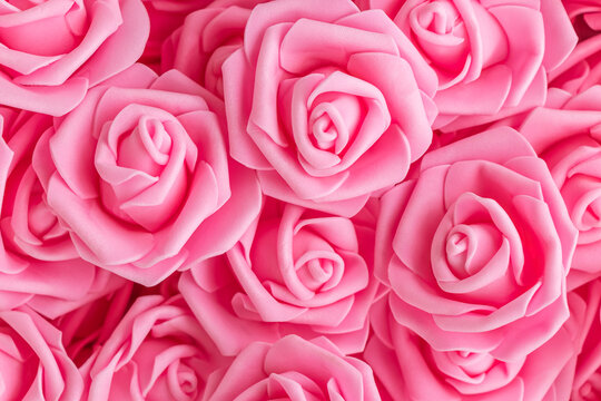 background of fake pink roses. Top view. soft focus