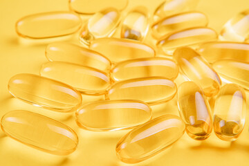 Omega 3 capsules.Vitamin drop pill capsule. Shining golden essence droplet. 
