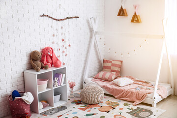 Stylish interior of modern children's room with soft carpet