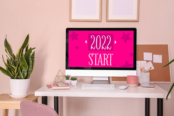 Text 2022 START on screen of computer monitor at workplace in office