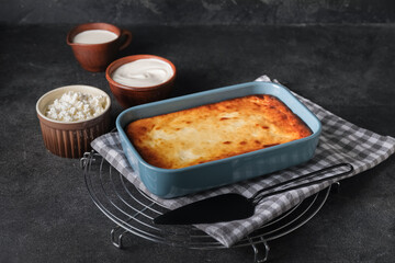 Dish with tasty cottage cheese casserole on table