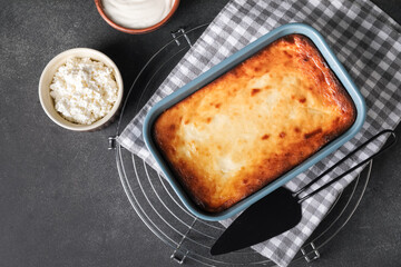 Dish with tasty cottage cheese casserole on dark background