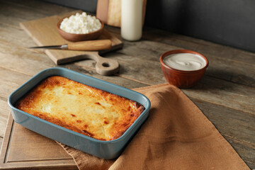 Dish with tasty cottage cheese casserole on table