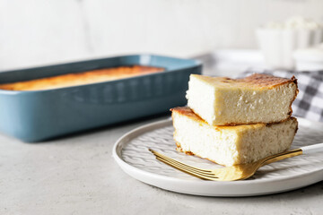 Plate with pieces of cottage cheese casserole on table