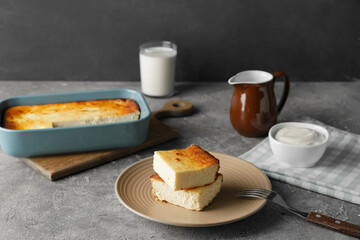 Plate with pieces of cottage cheese casserole on table