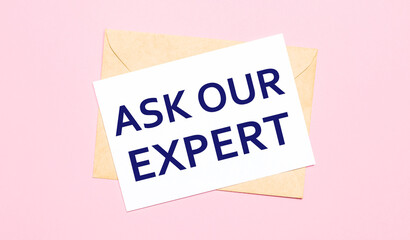 On a light pink background - a craft envelope. It has a white sheet of paper that says ASK OUR EXPERT.