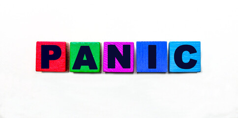 The word PANIC is written on colorful cubes on a light background