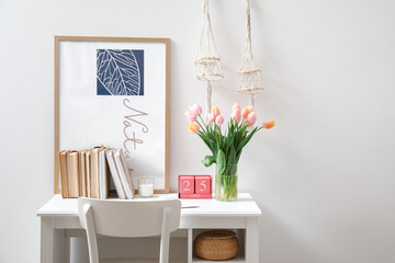 Bouquet of beautiful tulip flowers in interior of modern workplace