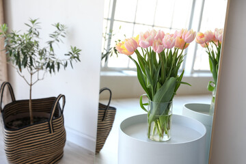 Bouquet of beautiful tulip flowers on table in modern room