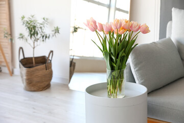 Bouquet of beautiful tulip flowers on table in modern room