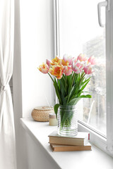 Bouquet of beautiful tulip flowers on windowsill