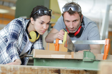 woman as apprentice for carpentry learning and working