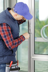 a man screws a window