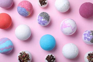 Colorful bath bombs on pink background, flat lay