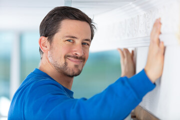 professional janitor cleaning baseboard with brush after renovation