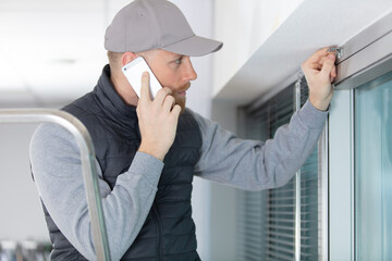 handsome repairman or builder talking with phone