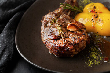 Roasted steak in frying pan on dark background - 433821670